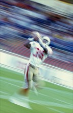 10086727 SPORT A Ball Games American Football American Footballer catching ball in motion blur