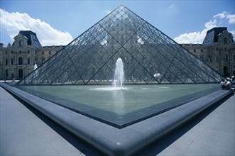 FRANCE, Ile De France, Paris, Louvre art gallery with a symetrical view of the Pyramid and fountain