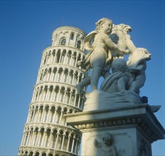 ITALY, Tuscany, Pisa, Leaning Tower with a statue in the foreground
