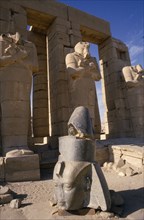 EGYPT,  , Luxor, Osirid columns in front of temple with head of statue on ground