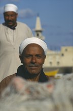 EGYPT,  , Alexandria, Two men wearing white turbans in front of mosque