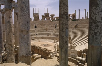 LIBYA, Tripolitania, Leptis Magna, The Roman amphitheatre seen from the stage area through columns