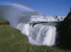 ICELAND, Gullfoss Falls, Also known as the Silver Waterfall with rainbow seen through water spray.