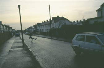 IRELAND, North, Belfast , Kids playing football in busy street