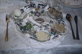 ISRAEL, Haifa, "Passover seder on table.  Lamb bone, unleavened bread, herbs, chopped apple mixed