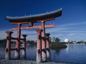 USA, Florida , Orlando , Walt Disney Epcot Centre. A red Japanese Torri Gate on lake with Spaceship