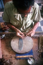 CUBA, Sancti Spiritus, Trinidad, Detail of worker rolling a cigar in factory