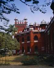 BANGLADESH, Dhaka, Curzon Hall.  Red and white exterior facade and gardens.