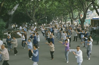 CHINA, Shanghai, Group of people taking part in Tai Chi exercise