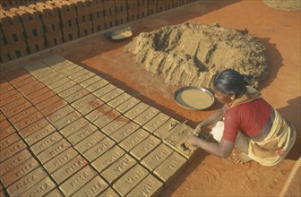 INDIA, Tamil Nadu, Woman making bricks in a brick works