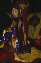 CHINA, Tibet  , Lhasa, Brightly dressed Monk chanting