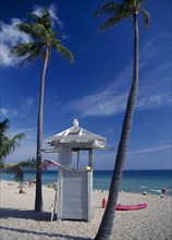 USA, Florida, Fort Lauderdale , Lifeguard hut on sandy beach beside coconut palm trees