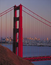 USA, California, San Francisco, Golden Gate Bridge at dusk with city behind