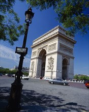 FRANCE, Ile de France , Paris, Arc de Triomphe and passing cars.