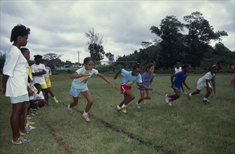10068036 JAMAICA   Sport Children competing in running race during school sports day.