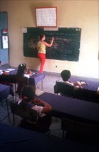 CUBA,  , Holguin, School classroom with teacher at blackboard