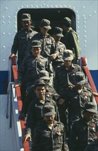 CUBA, Military, Soldiers descending steps of a plane after returning from Angola