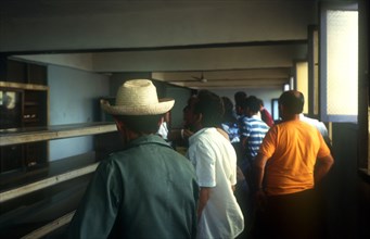 CUBA, Ciego de Avilar, Cafe Interior with queue of men standing along empty counter