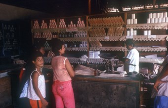 CUBA, Guantanamo Province, Paso de Toa, General Store with store person and customers standing at