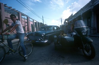CUBA, Los Pinos , "Mixed traffic of bicycle, motorbike and sidecar and taxi"