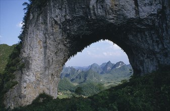 CHINA, Guangxi, Near Guilin, View through natural rock archway near the Li River framing