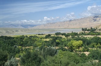 CHINA, Qinghai Province , Yellow River, Green trees and mountains with The yellow River in the
