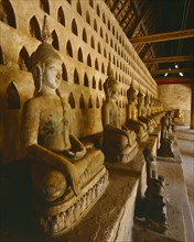 LAOS, Vientiane, "Wat Si Saket, the oldest city temple.  Interior with row of seated Buddha figures