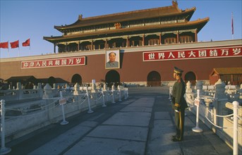 CHINA, Beijing, Tiananmen Square. Gate Heavenly Peace with soldier standing in the foreground