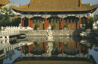 CHINA, Ningxia, Yinchuan , Pavilion in the Park reflected in pool in the foreground