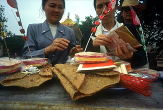 VIETNAM , Den Ba Chua Kho , "Women leaving offerings of money, food and incense at temple"