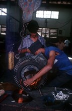 CUBA, Mariel, "Light industry, man in workshop fitting copper wire on to reel"