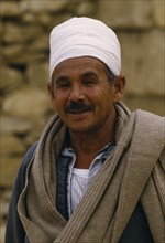 EGYPT, Cairo Area, Saqqara, Smiling guide wearing white turban