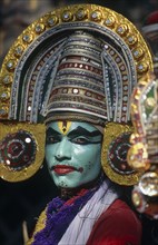 INDIA, Kerala, Dance, Kathakali dancer in costume with green face makeup