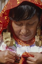 PANAMA, San Blas Islands, Cuna Indian woman sewing