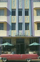 USA, Florida, Miami, Ocean Drive. Pink Cadillac parked outside Art Deco style Marlin Hotel on South