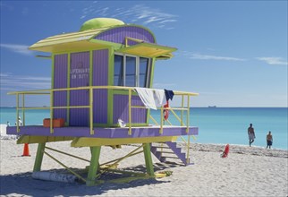 USA, Florida, Miami, Yellow green and lilac lifeguard hut on Miami beach