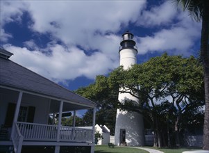 USA, Florida, Key West , Lighthouse Museum seen behind tree