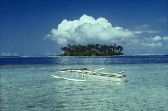 PACIFIC ISLANDS, Tahiti Moorea, Outrigger boat in clear sparkling water and Motu with large white