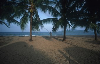 VIETNAM, South , Nha Trang , Sandy beach with palms looking toward the sea