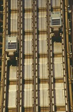 ENGLAND, London, Lloyds Building lifts with passenger on building exterior.