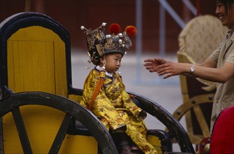 CHINA, Beijing, Little boy dressed as emperor for a photograph.