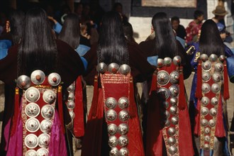CHINA, Guizhou, Tongren, Tibetan dancers at a festival wearing traditional costumes with silver