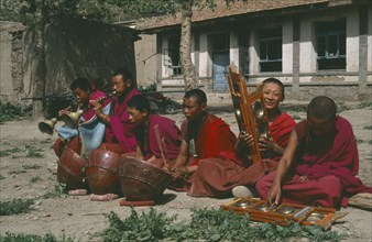CHINA, Gansu, Xiahe, Buddhist monks orchestra playing in courtyard of Labrabg monastery