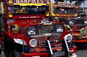 PHILIPPINES, Visayan Islands, Negros, Victorias. Close up of two brightly painted Jeepneys