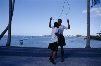 BERMUDA, Mangrove Bay, Schoolgirls playing with skipping rope.