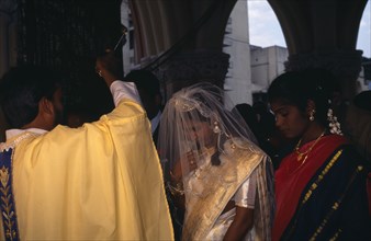 INDIA, Karnataka, Bangalore , "Christian wedding ceremony, bride and groom receiving blessing from