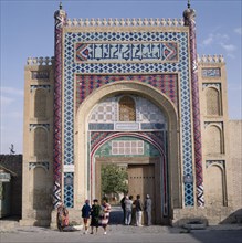 UZBEKISTAN,   , Bukhara, The Summer Palace. Local people at entrance gate with vivid mosaics