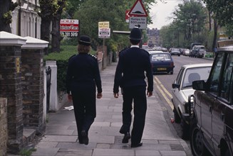 LAW & ORDER ,  , Police, "Policeman and woman on the beat, walking along city pavement."