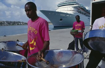 WEST INDIES, Antigua, St Johns, The Halcyon Cove Steel Band playing on quayside with cruise ship