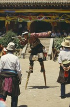 CHINA, Qinghai, Tongren, Tibetan stilt dancer at festival